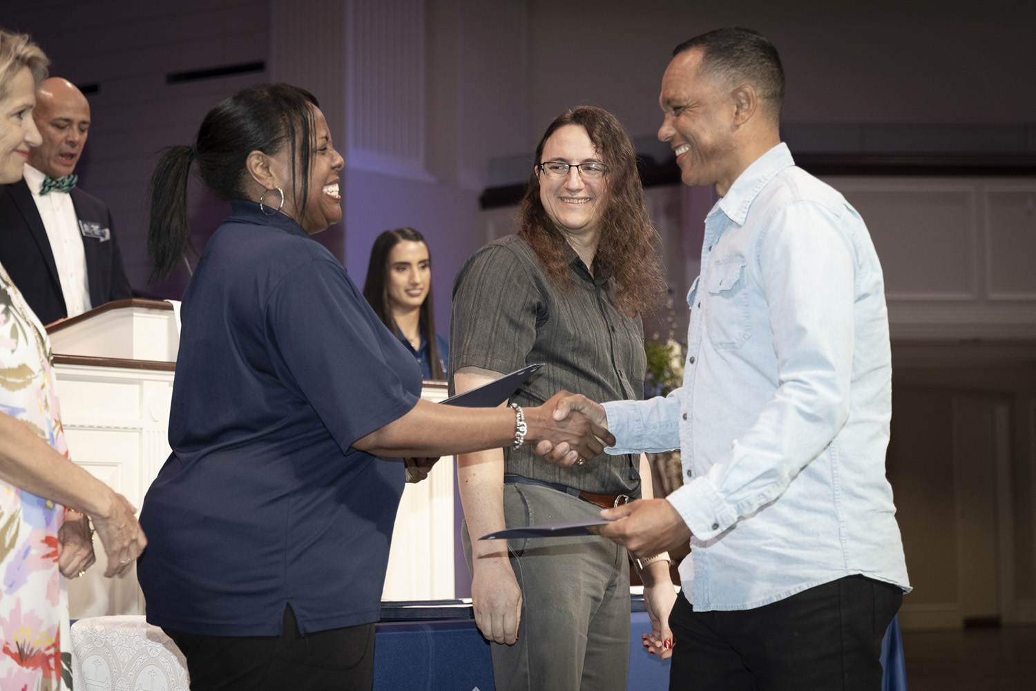 Camale Allen and Eric Ables of Collin College with automotive graduate Vincente Tillero