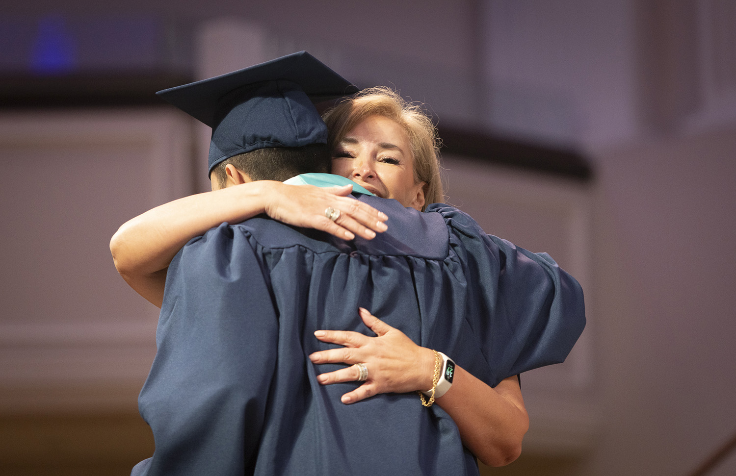 Ligia Urrego hugs a graduate